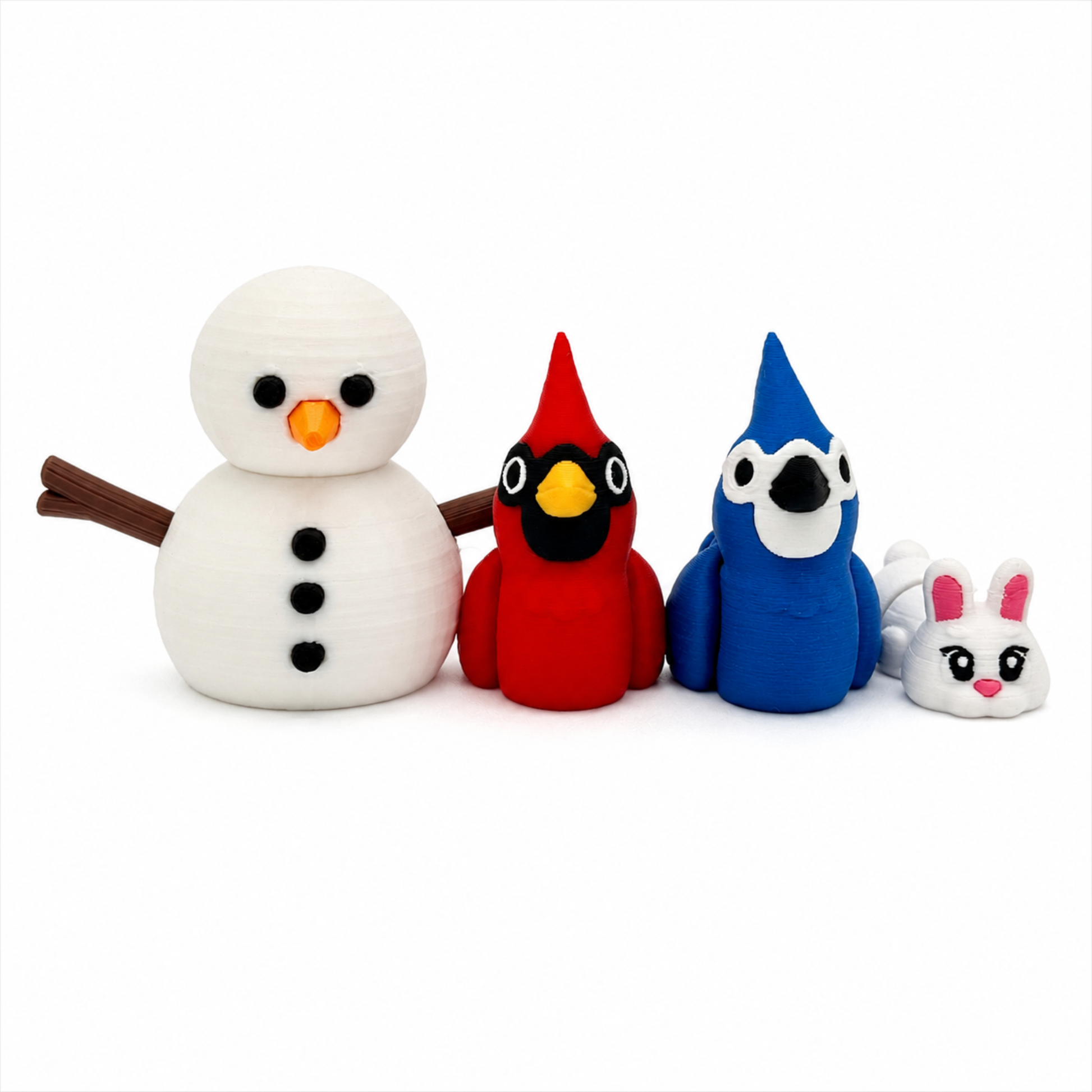 Close-up of miniature winter snowman sensory play set highlighting detailed 3D printed snowman, cardinal, blue jay, bunny, and accessories for storybook extension activities and imaginative play.