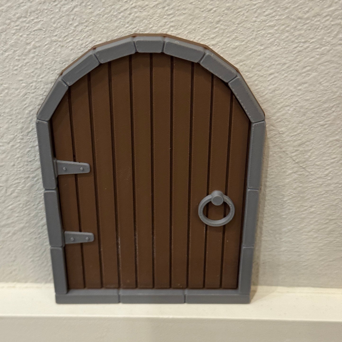 brown storybook door for holiday displays or pretend play setups sitting on wall trim