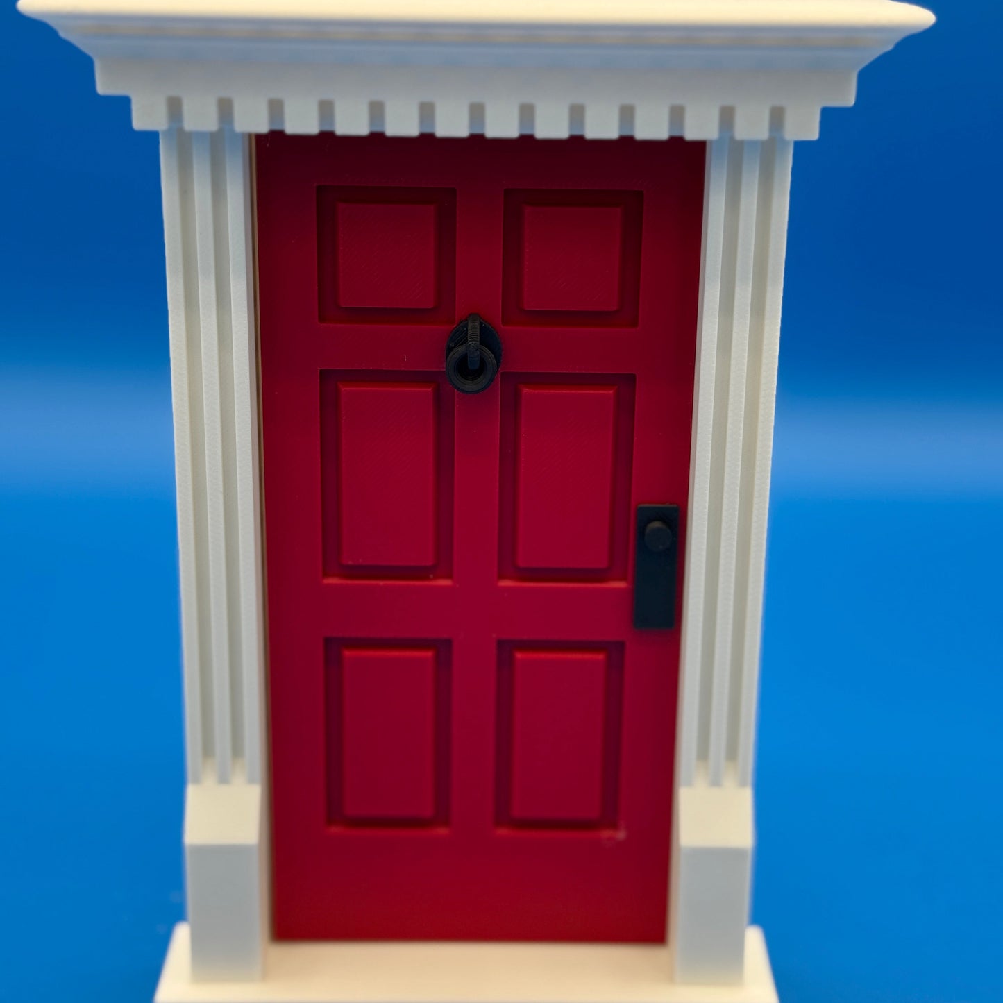 Traditional red miniature door with white frame – holiday elf entryway prop for shelf displays”