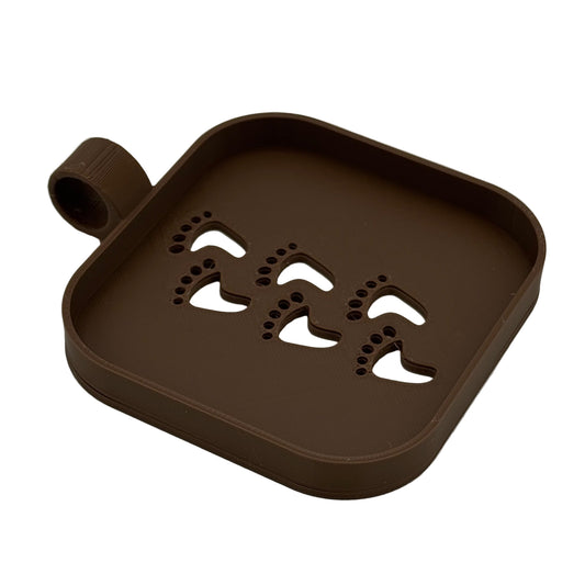 3D printed elf footprint stencil used to sift flour and create tiny tracks
