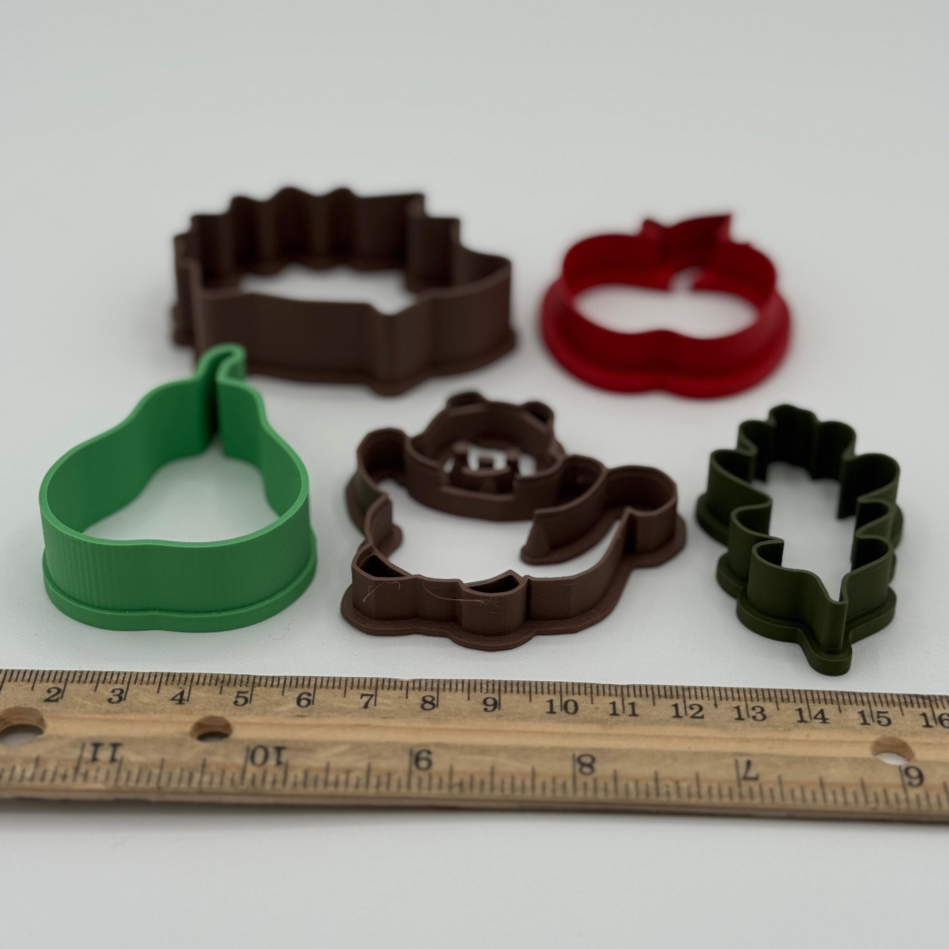 Fall-themed play dough cutters including apple, leaf, pear, and hedgehog shapes, 3D printed sensory tools for kids