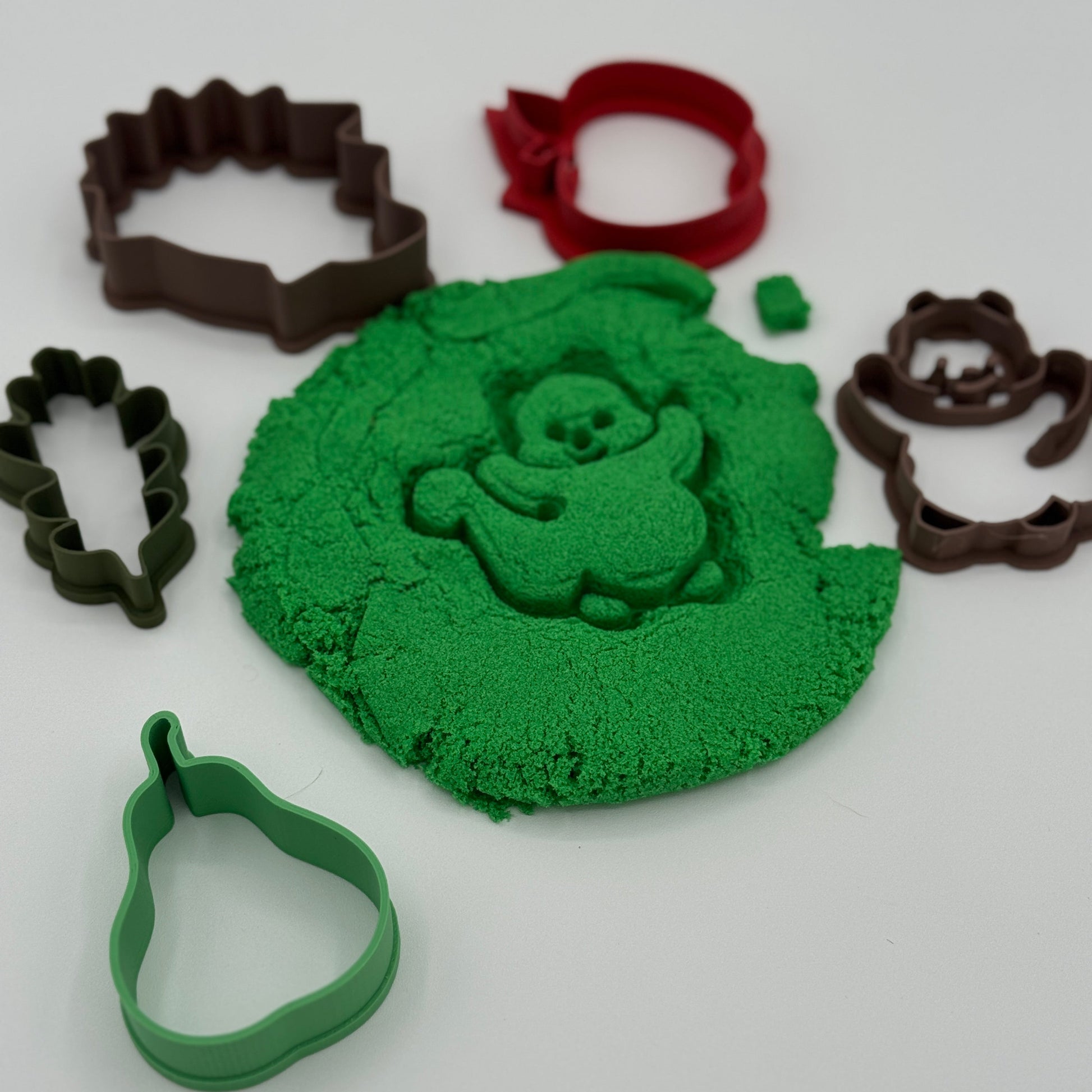 Play dough pressed with fall cookie cutter shapes for sensory play and fine motor practice