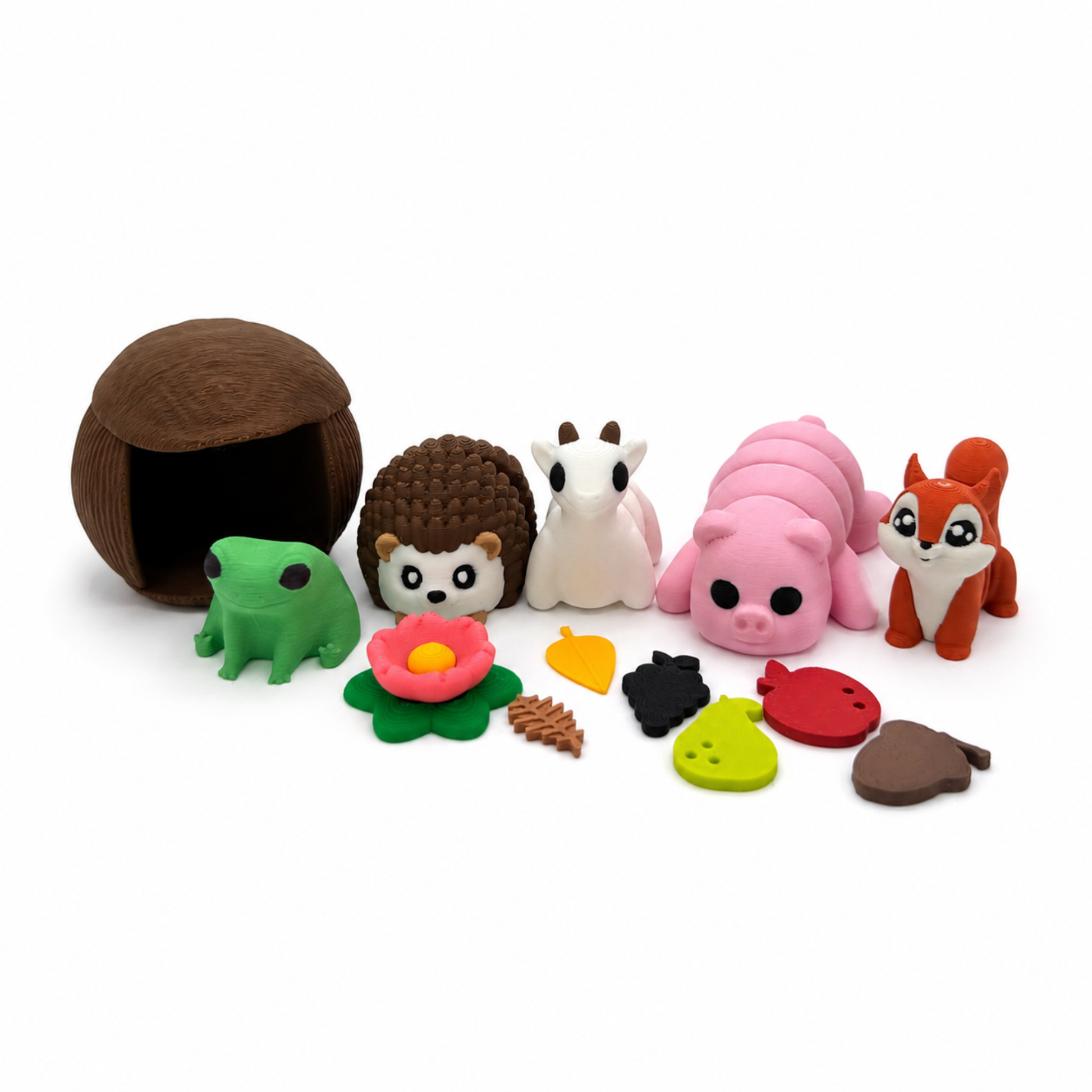 Close-up of the Hedgehog and Friends miniature play set showing the woodland animals, textured hut, flowers, leaves, and story pieces.