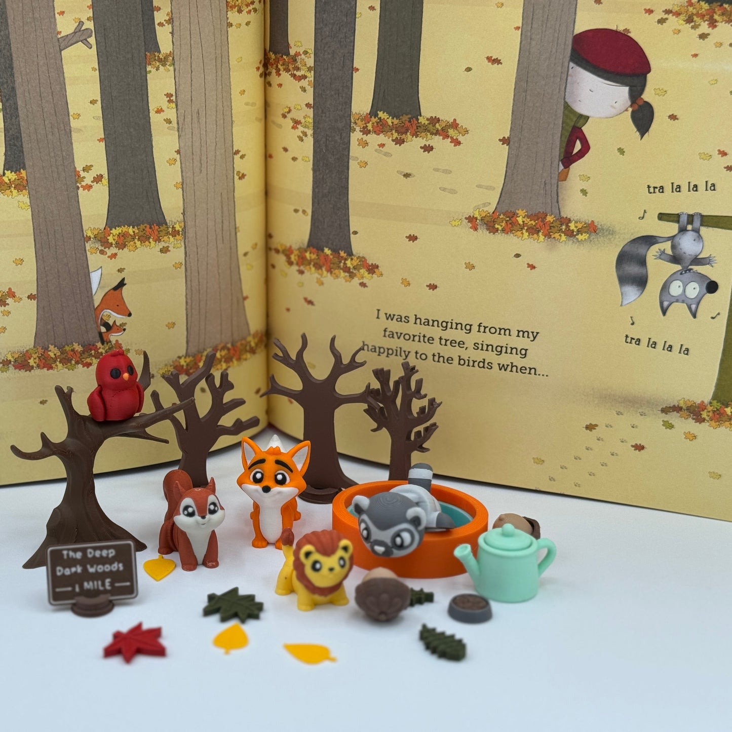 Storybook character miniatures arranged for fall sensory play and storytelling activities
