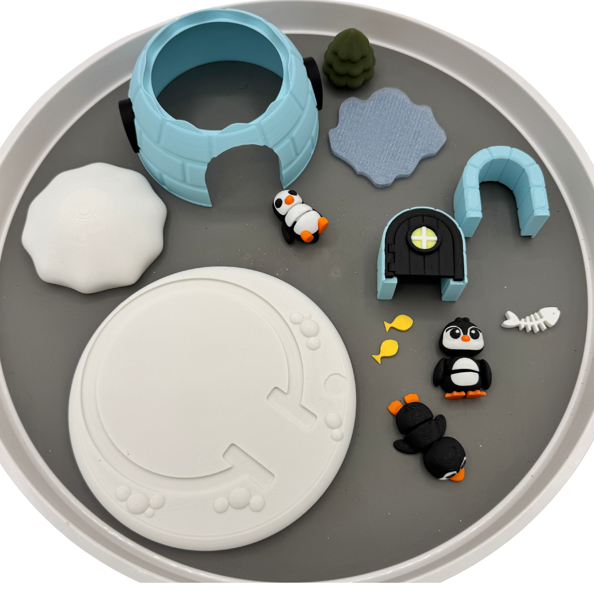 Top view of penguin igloo play set showing all pieces arranged on sensory bin tray