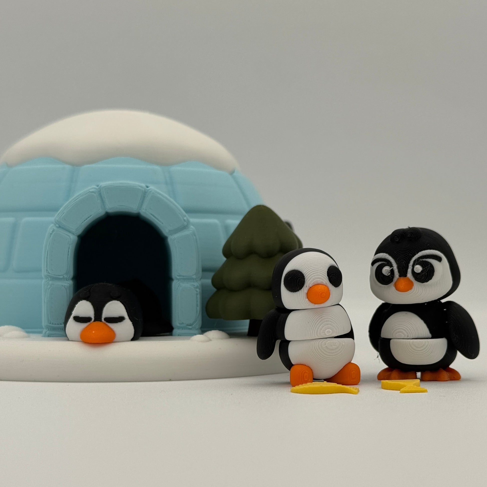 Penguin figures interacting around an igloo playset to encourage open-ended storytelling