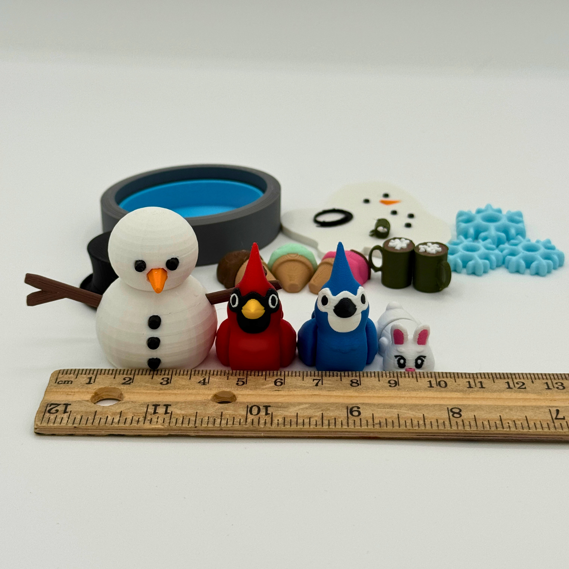 All pieces included in the winter storybook character set laid out to show individual 3D printed figures and play props