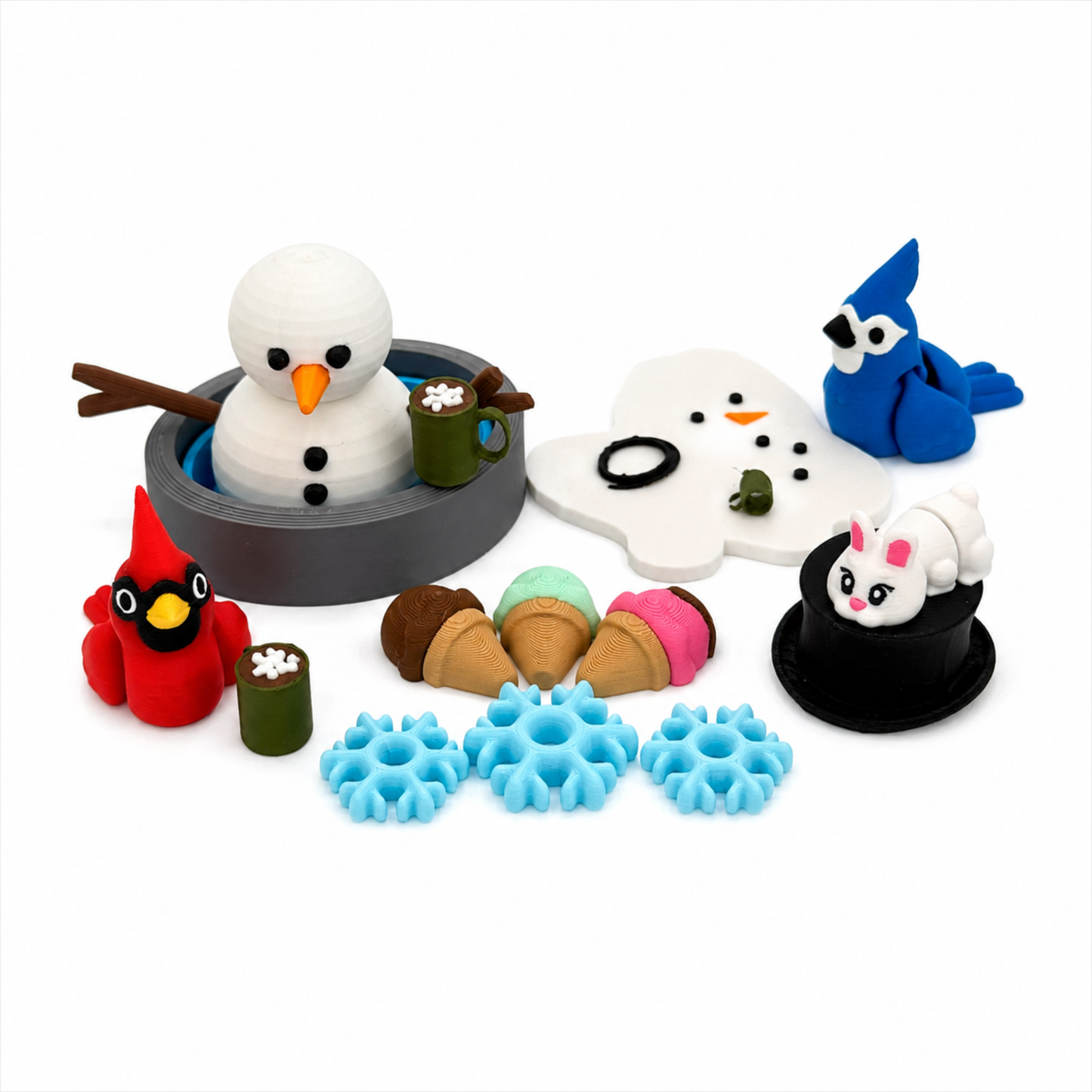 Everything included in the winter snowman sensory play set featuring snowman, cardinal, blue jay, bunny, snowman face, hot cocoa mugs, snowflakes, treats, and play tray for small world storytelling.