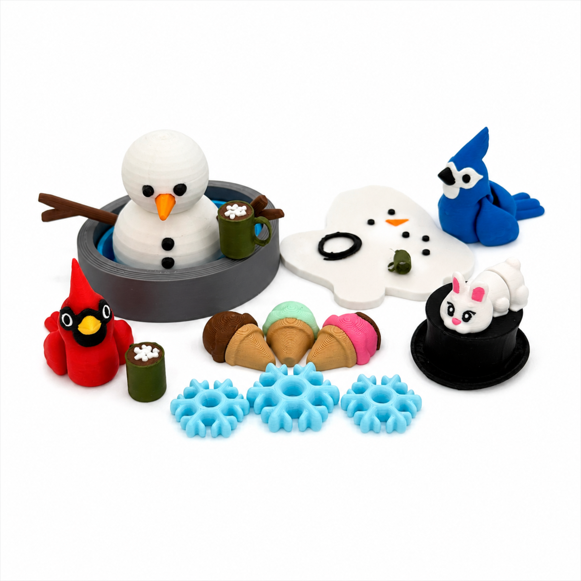 Everything included in the winter snowman sensory play set featuring snowman, cardinal, blue jay, bunny, snowman face, hot cocoa mugs, snowflakes, treats, and play tray for small world storytelling.