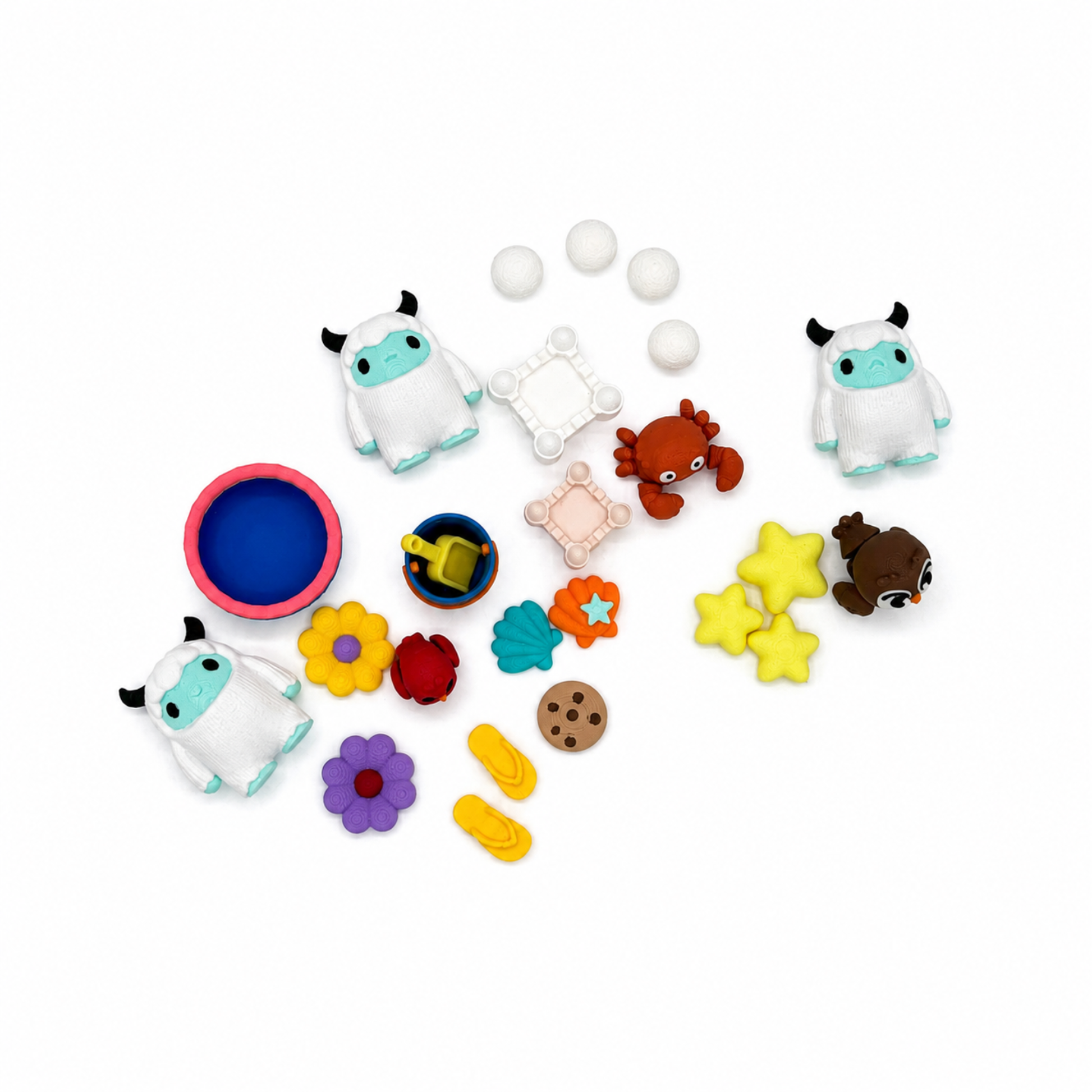 Everything included in the Yeti & Friends sensory play set featuring miniature yetis, bucket and shovel, flowers, stars, crab, owl, cookie, sandcastle, and storytelling accessories.
