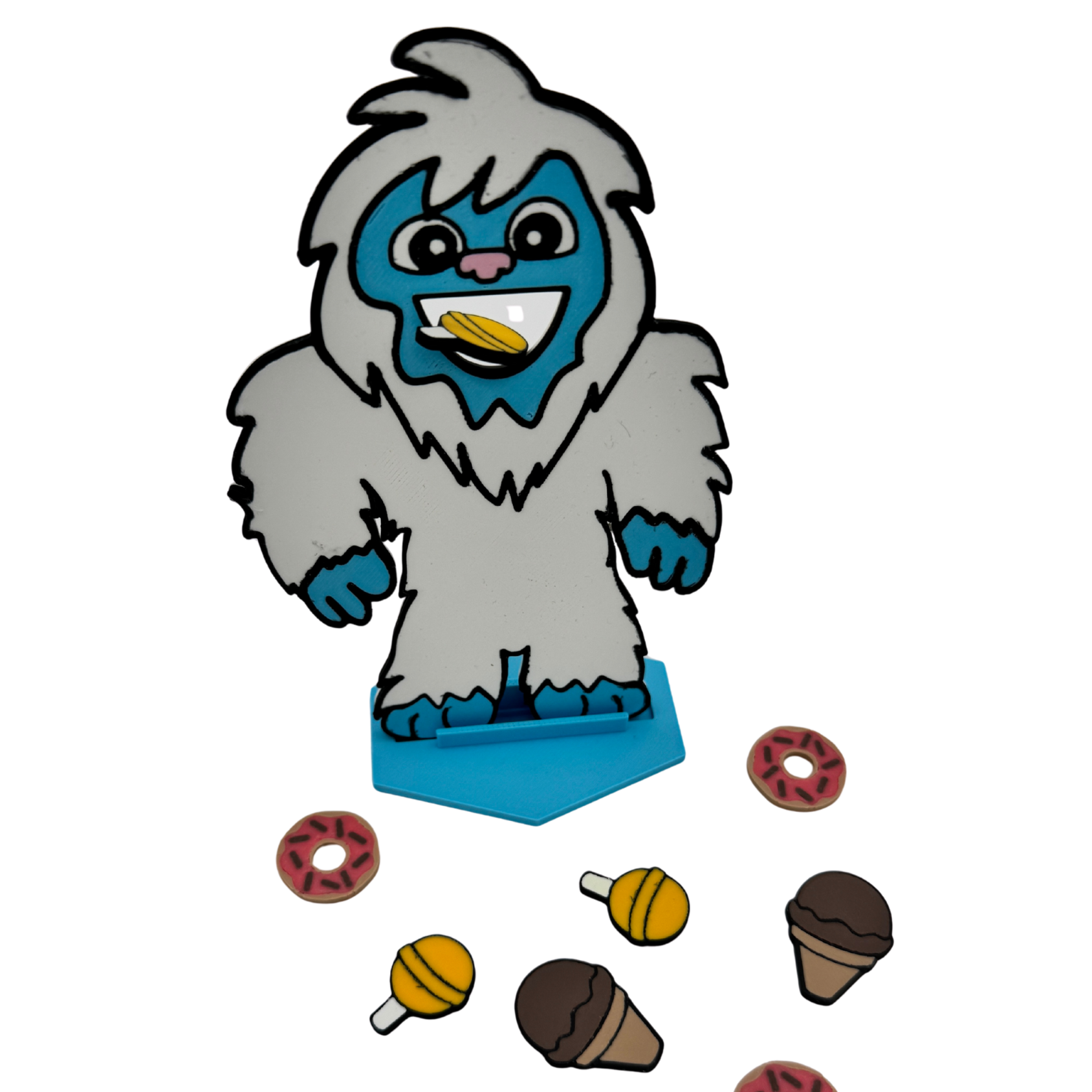 Close-up of Feed the Yeti character with colorful feeding pieces on white background