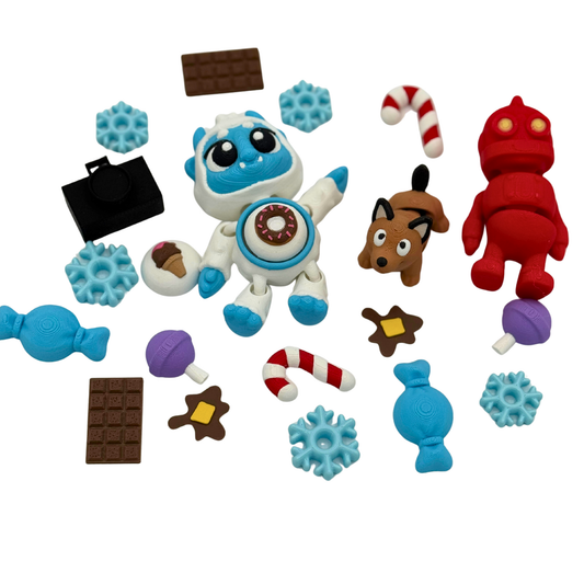 BriteBerry storybook character set featuring a clickable tummy yeti, articulated robot and dog, snowflakes, candy pieces, camera, and winter-themed accessories for guided storytelling play